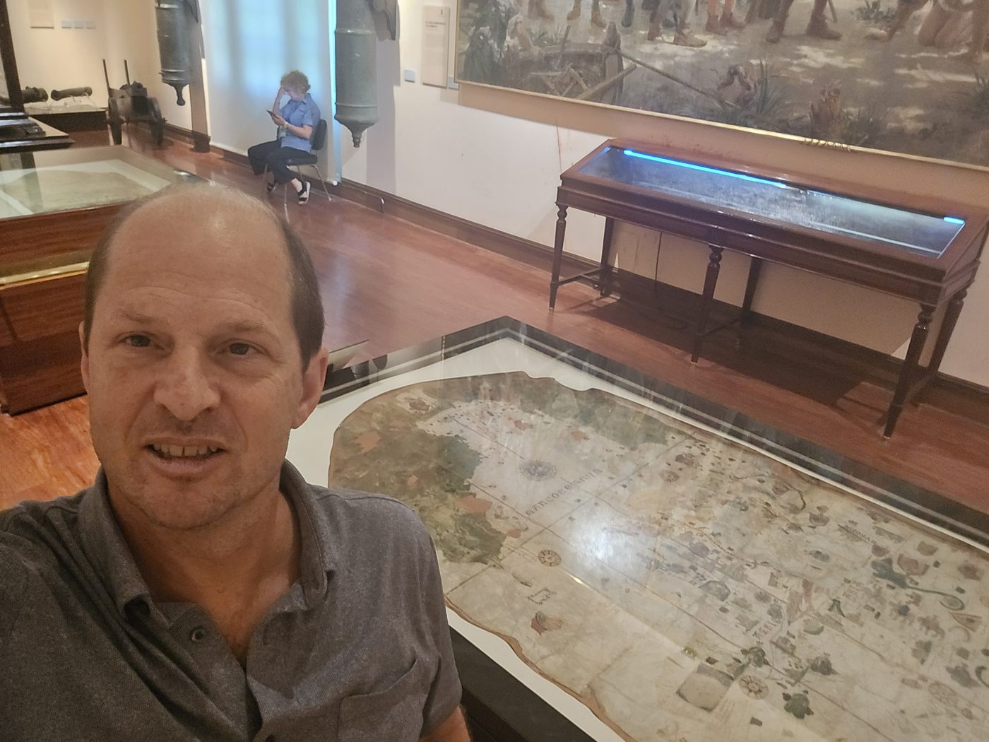 Graham Balch standing beside the Juan de la Cosa map on display at the Museo Naval in Madrid