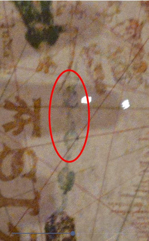 A separate island on the De la Cosa map showing the same reddish pigment fading pattern as Guanahani