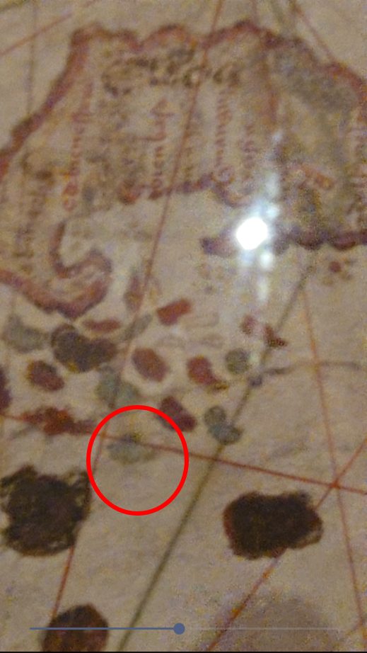 A labeled island on the De la Cosa map with pigment loss and dotted outline breaks