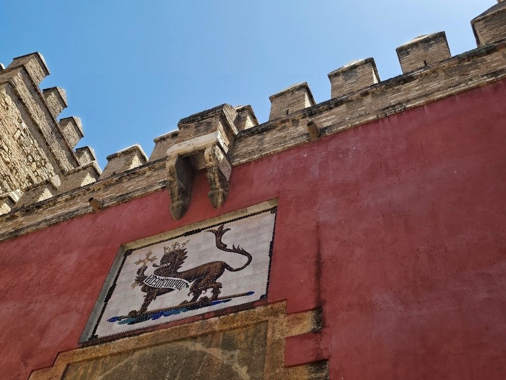 The Puerta de León gate at the Alcázar of Seville, with a painted lion crest