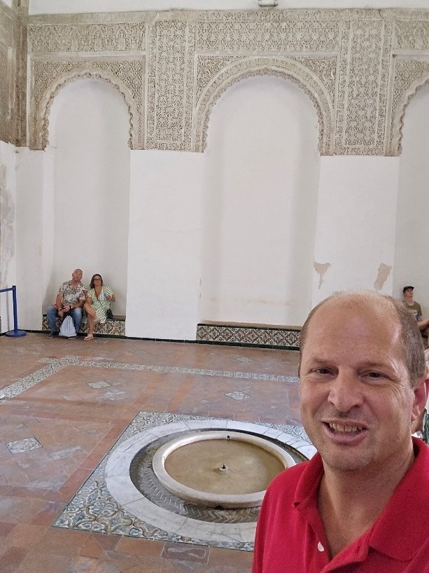 Graham Balch beside the fountain in the Hall of Justice at the Alcázar of Seville