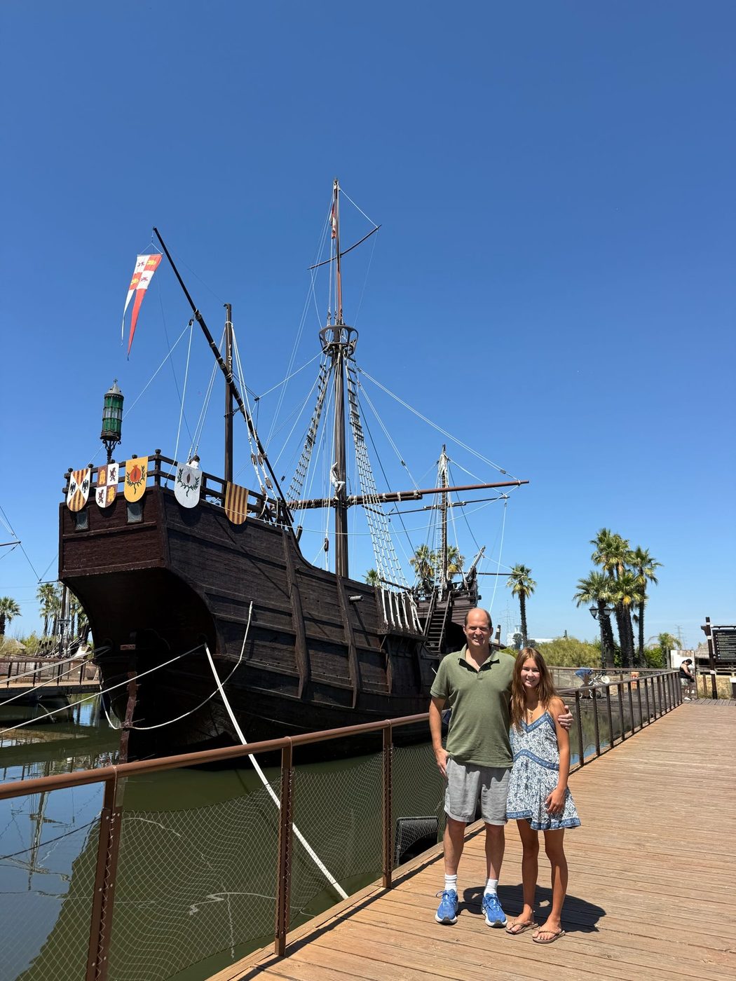 Graham Balch and his daughter beside a replica of Columbus's ship at La Rábida, Spain